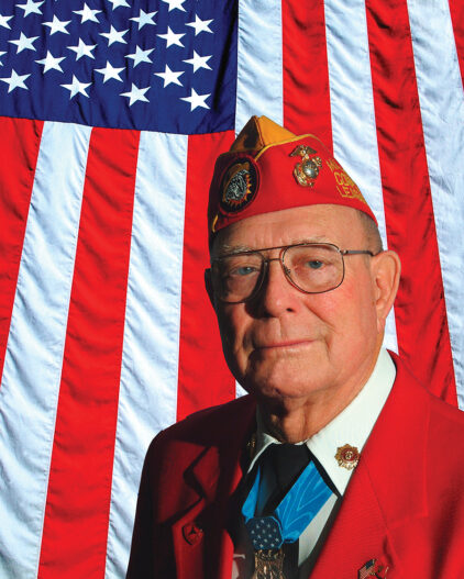 veteran in front of American Flag